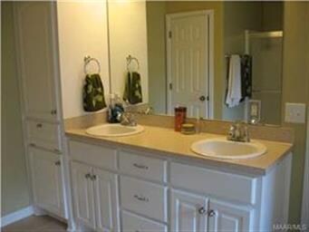 Master bath with double vanities and linen cabinet