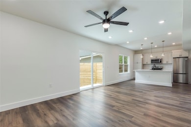 Unfurnished living room featuring baseboards, a c
