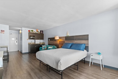 Bedroom featuring dark wood finished floors and a textured ceiling
