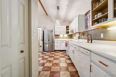 Kitchen featuring white appliances, white cabinetr