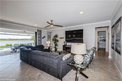Tiled living room featuring ceiling fan, a water v