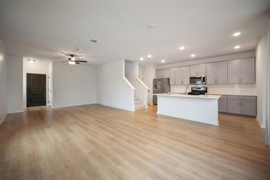 Kitchen featuring gray cabinets, light wood-style
