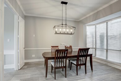 Spacious dining room with elegant lighting.  Measu