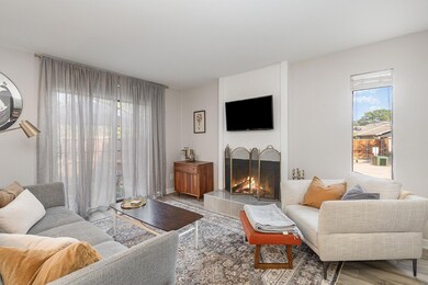 Living room with light hardwood / wood-style floor
