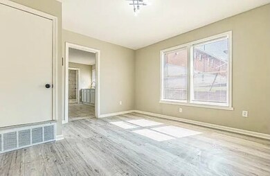 Spare room featuring wood finished floors and baseboards