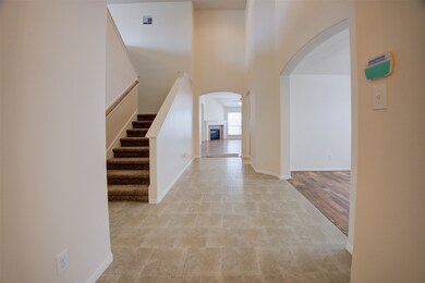 ENTRY VIEW OF STAIR TO GAMEROOM, DINING ON RIGHT AND FAMILY ROOM STRAIGHT AHEAD