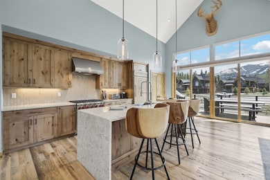 Kitchen featuring wall chimney exhaust hood, high