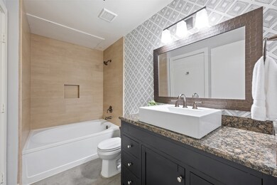 Stylishly updated bathroom featuring a modern vani