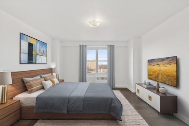 Bedroom with dark wood-type flooring and baseboards
