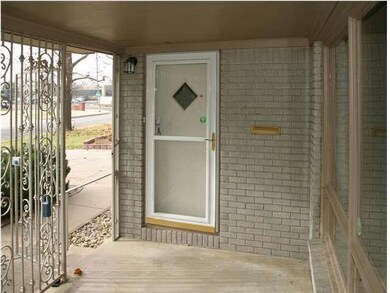 FRONT ENTRY WITH WROUGHT IRON ENCLOSED COVERED FRO