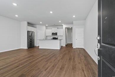 Unfurnished living room with baseboards, dark wood