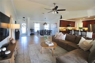 Living room with ceiling fan, light tile patterned