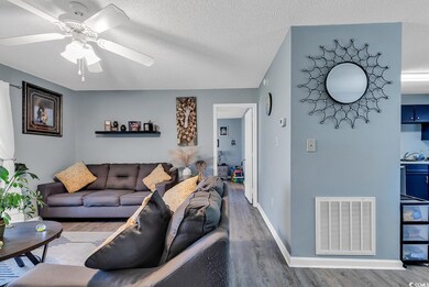 Living area with baseboards, visible vents, a ceil