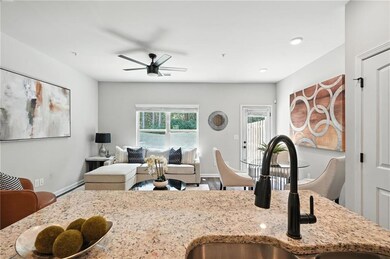 Kitchen featuring a ceiling fan, light stone counters, open floor plan, and recessed lighting
