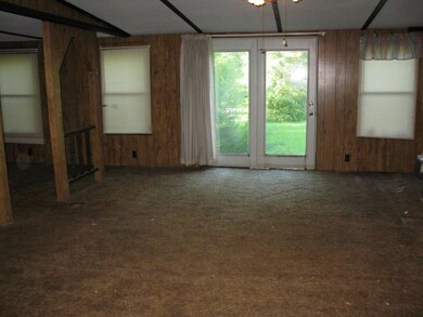 The living room and front door. There is no porch or steps for you to use the front door.You will need to enter thru the back door.