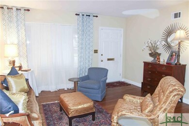 Formal living room with wood floor.