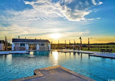 Pool at dusk featuring a patio
