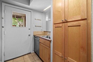 Kitchen with dishwasher and light tile patterned 