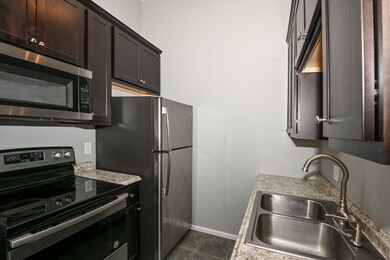 The galley kitchen is finished with a ceramic tile