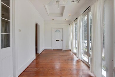 Sunroom has pine floors