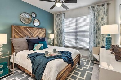 Bedroom with dark carpet and ceiling fan