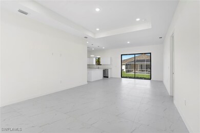 Unfurnished living room with a raised ceiling, mar