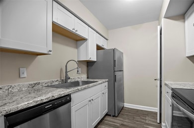 Kitchen featuring sink, granite countertops,  stai