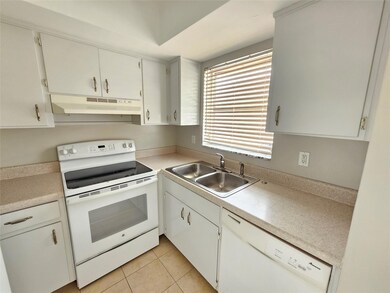 Kitchen with white cabinets and appliances with wi