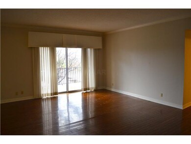 Living room with balcony entrance, neutral paint a