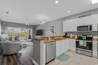 Kitchen featuring white cabinets, appliances with 
