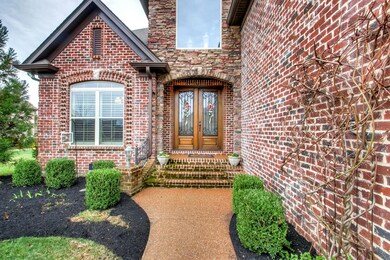 Stately entry draws you in with the beautiful entry doors and landscaping.
