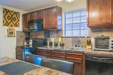 View of the kitchen with wood cabinets, electric s
