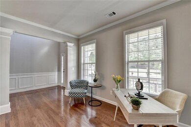 Office space featuring ornate columns, wood finish