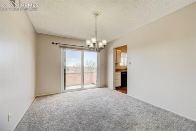 Empty room with a textured ceiling, a chandelier, 