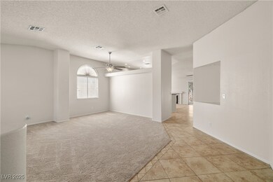Unfurnished room with a ceiling fan, light tile pa