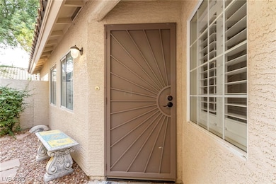 Doorway to property featuring stucco siding