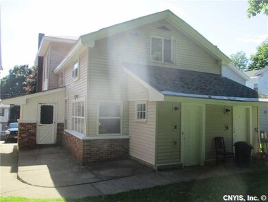 Backyard. THE BACK OF THE HOME...WITH ENTRANCES TO