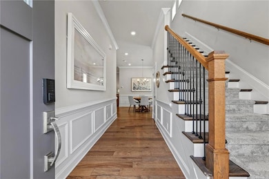 Foyer featuring stairs, crown molding, a decorativ