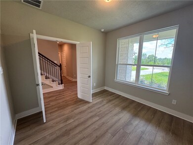 Unfurnished room with wood finished floors, a text