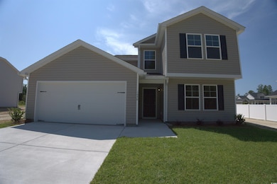 View of front of home featuring a garage and concrete driveway