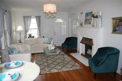Lovely Living/Dining combo with gleaming hardwoods and unique fireplace!