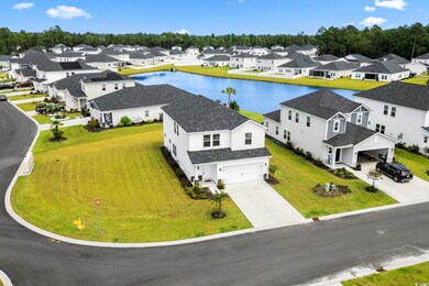 Aerial view of residential area featuring a nearby body of water