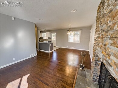 Unfurnished living room featuring dark wood floori