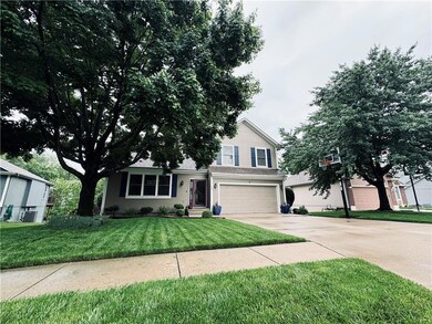 View of front facade featuring a front lawn and a garage
