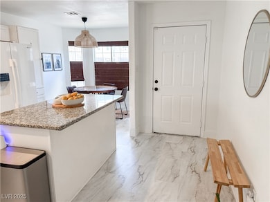 Kitchen featuring visible vents, hanging light fix