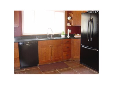 18 inch terracotta tiles, custom built maple cabinets, black appliances stay, including gas range