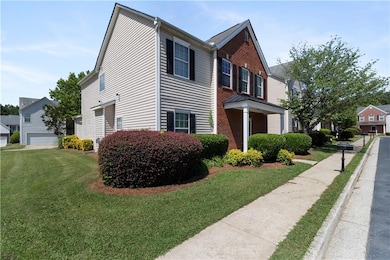 View of front facade featuring a front lawn and brick siding