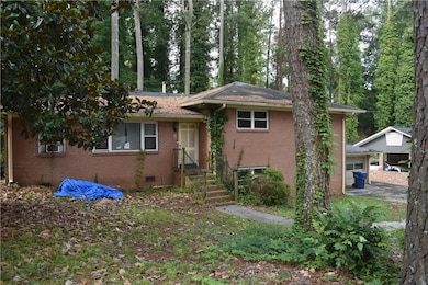 View of front facade featuring brick siding, a garage, and crawl space