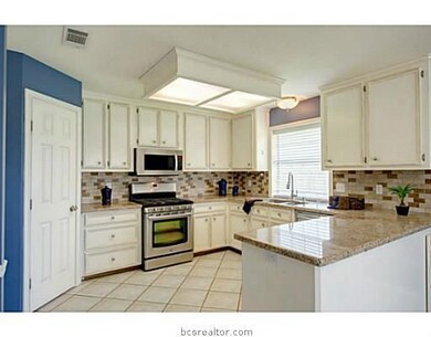 Kitchen. This unique kitchen features granite countertops, beautiful tile backsplash, gorgeous custom cabinetry, and a walk-in pantry.