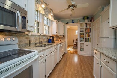 The smashing white kitchen offers a display ledge,